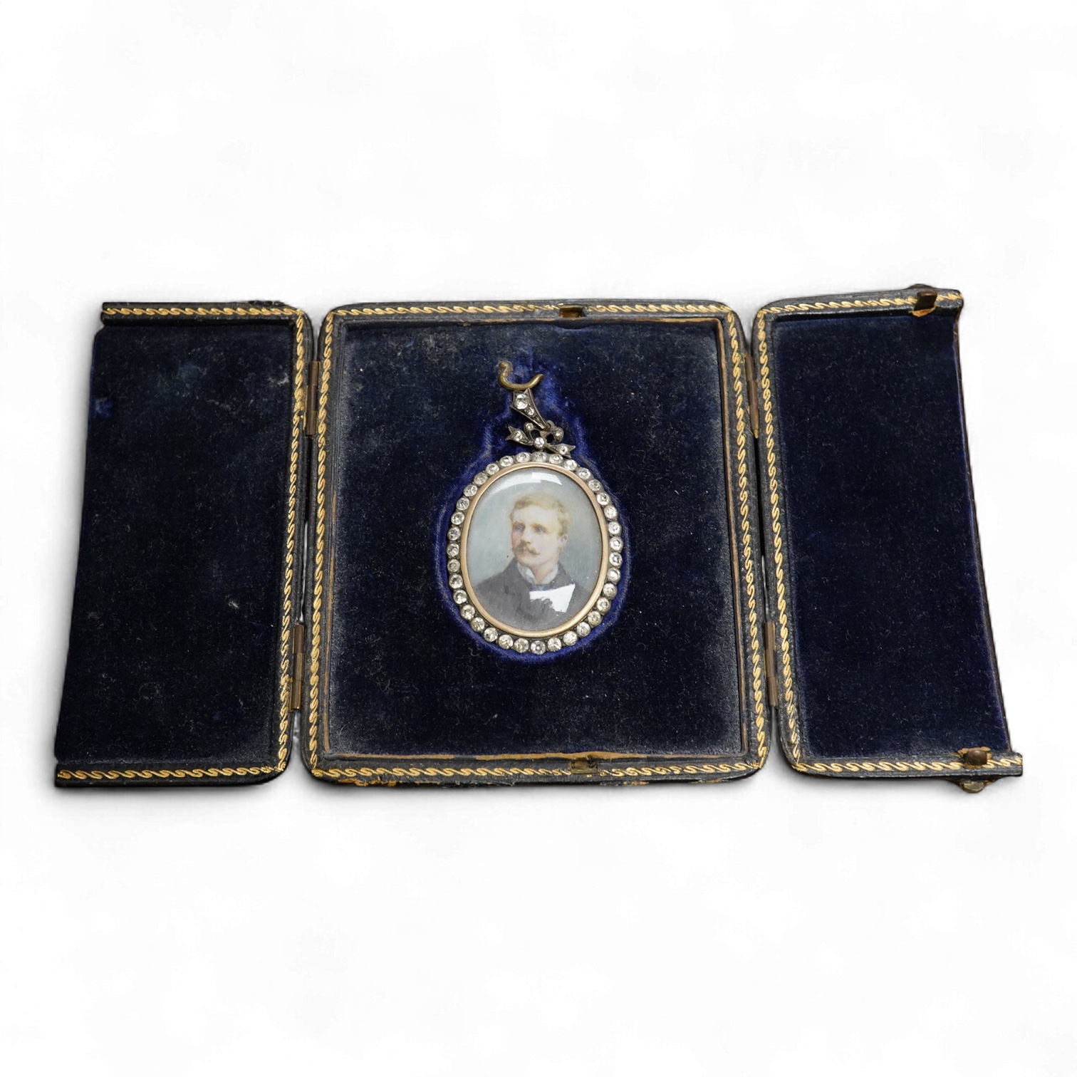 Early 20th century school, Portrait miniature of a gentleman, oval watercolour on ivory, housed in a silver and paste pendant frame, with gilt tooled leather case, 3.5 x 2.5cm CITES Submission reference 5A81E2GB